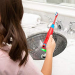 Side profile of the battery operated Elmo game brush highlighting the ergonomic grip for toddlers