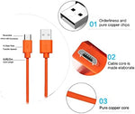 Orange Micro USB charging cable connected to a removable security camera battery pack.