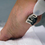 Tweezerman dual action foot file showing the slide and lock safety mechanism.