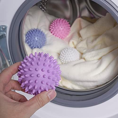 Eco-friendly laundry balls separating clothes in a dryer for better air circulation.