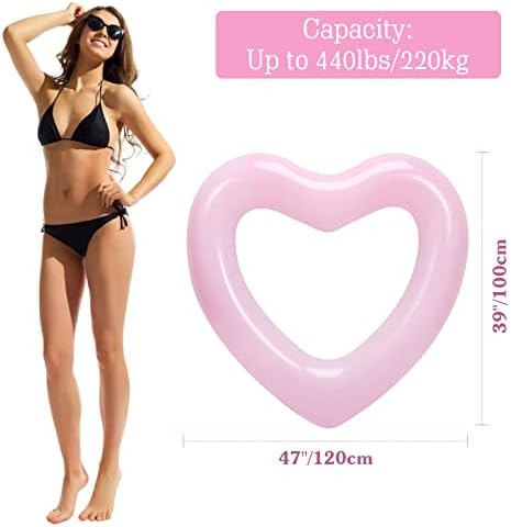 Adult lounging on a large heart-shaped pool float in a swimming pool