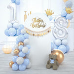 Elegant white fabric arch setup decorated with celebration balloons.