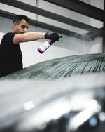 CarPro IronX 500ml bottle beside clean car wheel
