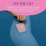 Compact travel size feminine hygiene wipes being placed into a small handbag.