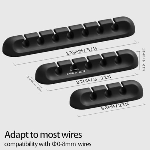 Black silicone self adhesive cord holder pack of ten displayed on a wooden table surface