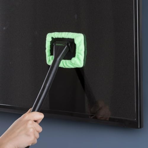 Multi purpose reach cleaning tool being used on a household glass shower door and mirror surface