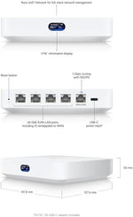 Ubiquiti Cloud Gateway Ultra security firewall device placed on an office desk demonstrating its small space-saving footprint.