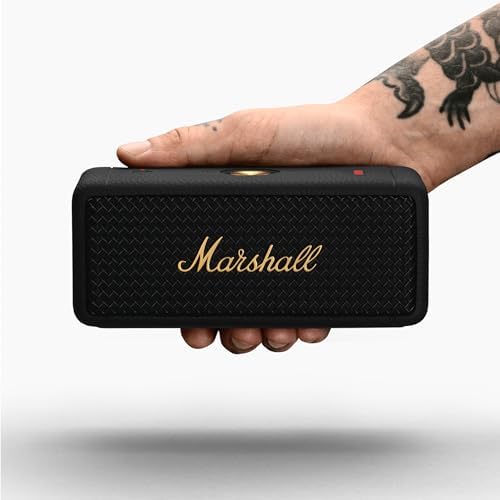 Close up of Marshall logo on Emberton II black and brass speaker