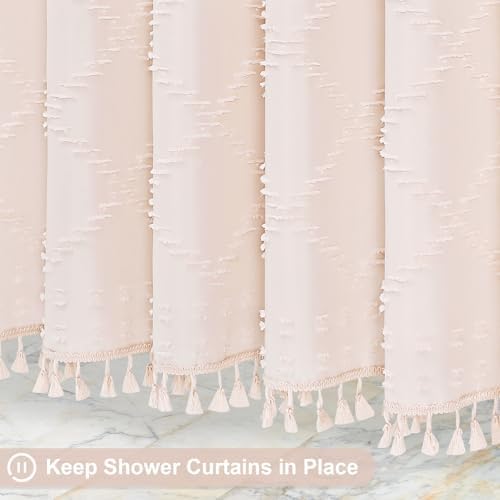 Detailed shot of the delicate white tassel trim detailing along the bottom edge of the blush pink curtain.