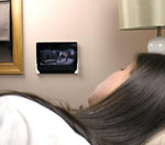 Sleek universal tablet stand attached to a smooth kitchen wall surface