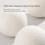 Three white wool dryer balls used for reducing laundry drying time and static.