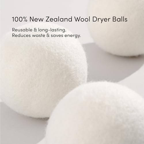 Three white wool dryer balls used for reducing laundry drying time and static.