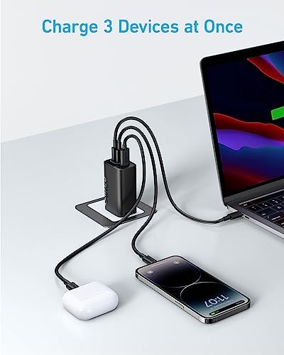 Anker multi port charging adapter shown next to a laptop and smartphone