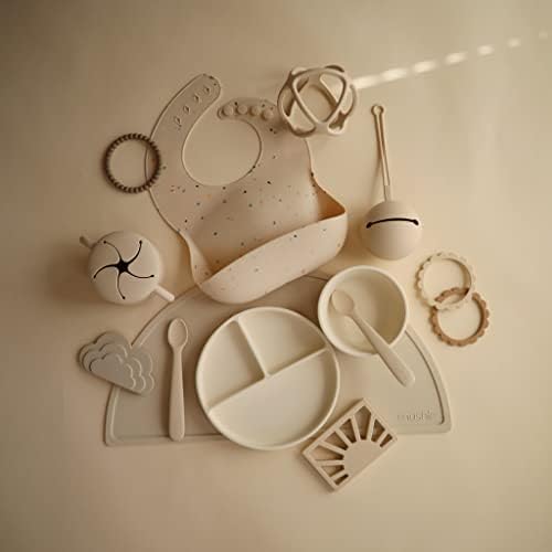 Mushie travel pacifier case showing its compact dimensions and earthy neutral color