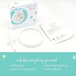Completed round DIY baby handprint ornament hanging as nursery holiday decor