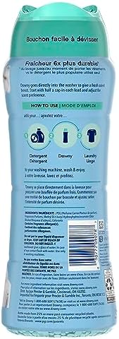 Close up of blue Downy scent booster beads for long lasting laundry fragrance.