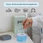 Invisalign clear aligners soaking in blue mint flavored cleansing solution