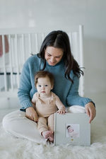 Pearhead baby memory book open page layout displaying internal photo pockets and side journaling notes area.