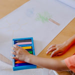 Close up of the non roll triangular plastic coloring crayons for toddler grip development.
