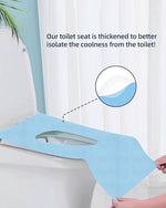 Disposable toilet shield draped over a public restroom toilet seat for full coverage