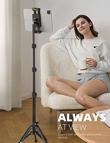Lamicall height adjustable floor mount fully extended to sixty-five inches next to a standing person.