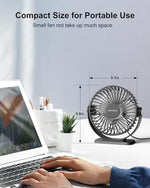 TriPole portable fan plugged into a laptop showing its compact size next to office stationery.