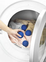Close up of Whitmor blue dryer balls showing spiked texture for fabric softening.