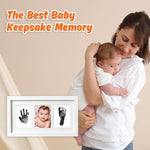 Infant handprint and footprint keepsake frame with newborn photograph displayed on a tabletop