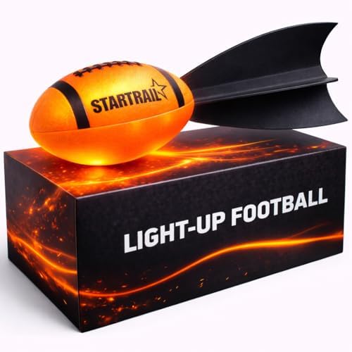 Size six glow football illuminating a backyard grass field after sunset