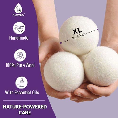 Reusable wool dryer balls being placed into a laundry dryer for faster drying