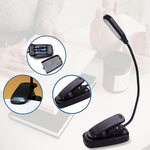 Flexible gooseneck reading light clipped to a book
