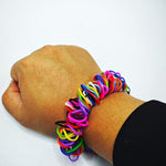 Three distinct colored stretchy sensory loom bracelets worn on a wrist for discreet habit reversal.