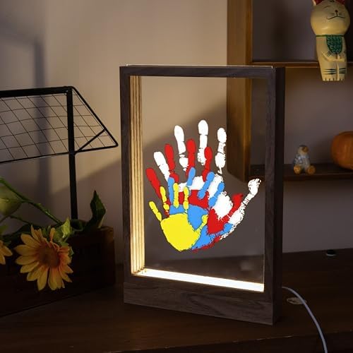DIY keepsake memory frame with layered colorful family handprints