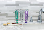 Texture shot of the dense and creamy white paste alongside its elegant Italian packaging