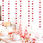Photo booth background showcasing multiple strands of love shape streamers