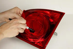 Applying the 3M high strength taillight repair patch to a curved car lens