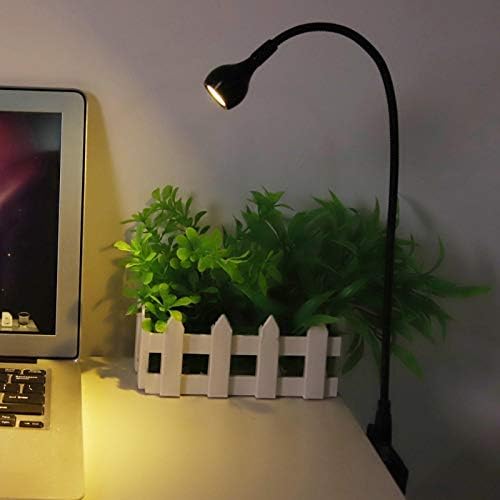 Tyenaza portable desk light plugged into a laptop USB port illuminating the keyboard