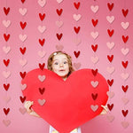 Romantic photo booth background created with multiple strands of heart banners