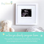 Tiny Ideas pregnancy announcement frame with teal script lettering displaying a four by five inch sonogram photo.