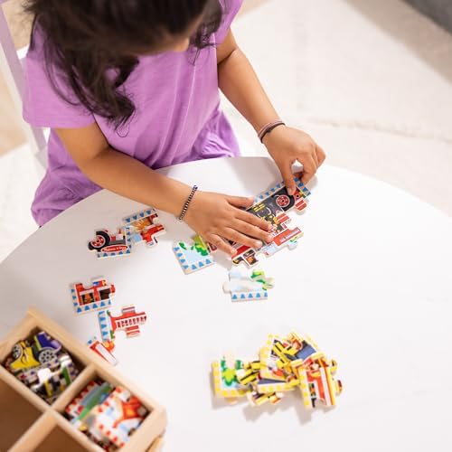 Toddler using the sliding wooden box lid as an assembly board for the fire engine puzzle