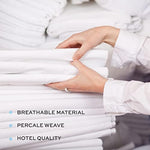 Side view of stacked White Classic white flat bed sheets highlighting clean finished hems