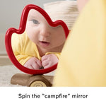 Close up view of the Fisher-Price spinning mirror campfire toy with soft ribbon taggies for tummy time.