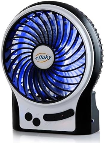 Compact efluky battery operated fan being packed into a travel backpack for outdoor camping.