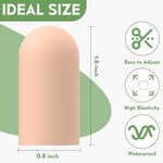 Trimming a nude color rubber finger sleeve with scissors to demonstrate custom length adjustments.