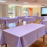 Purple table cover applied to banquet table setup