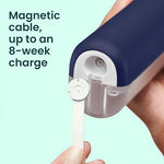 Quip cordless water flosser being charged with its magnetic USB charging cable.