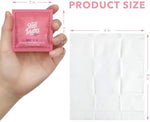 Individually wrapped Stall Mates travel wipes spread out on a white surface.