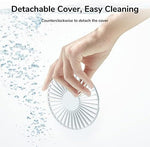 JISULIFE white pocket fan illustrating its lightweight and compact size relative to a handbag