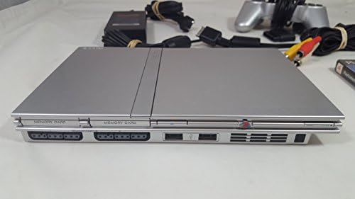 Imported Sony PlayStation 2 controller in silver showing twin thumbsticks and analog buttons.