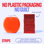 Compact 3 count packaging of plant based travel detergent sheets resting next to a packed suitcase.